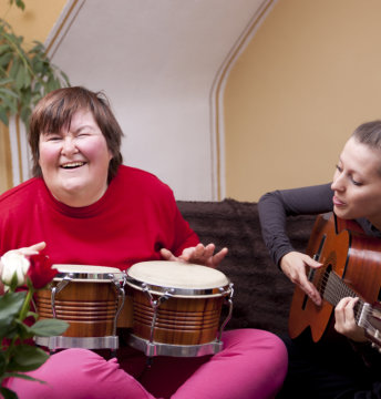 Two women playing instruments while having fun