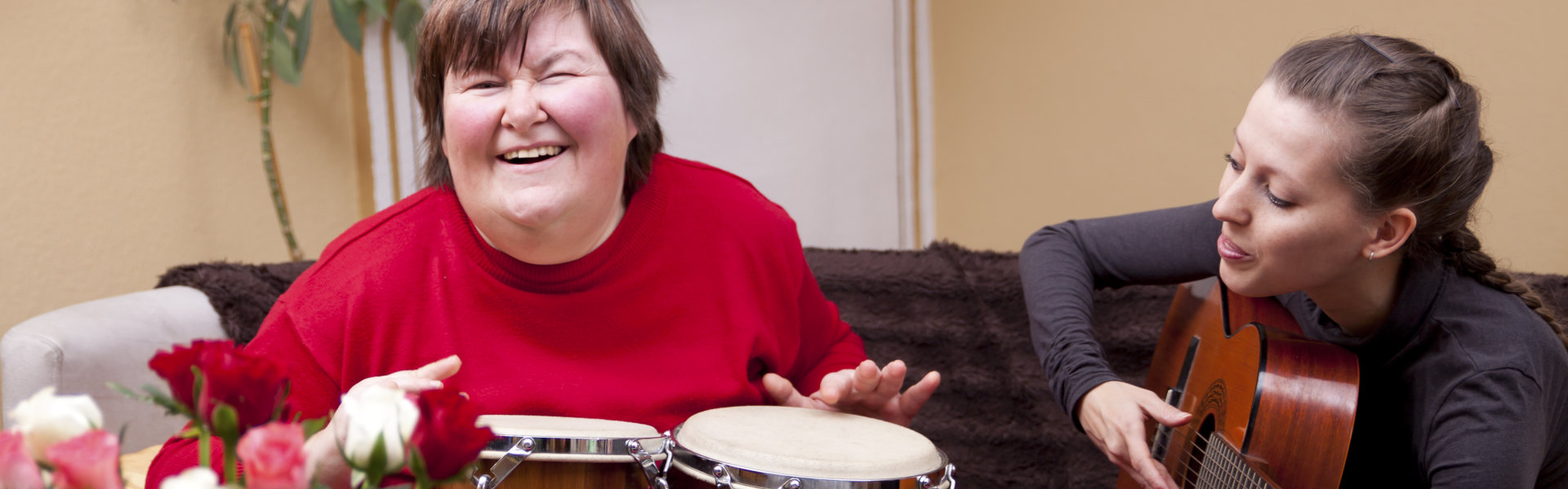 Two women playing instruments while having fun